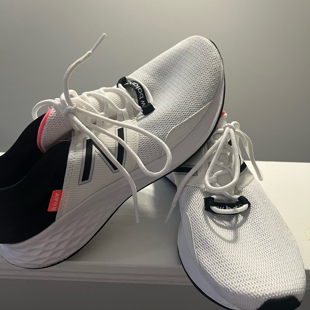 White, Blake and Pink New Balance tennis shoes